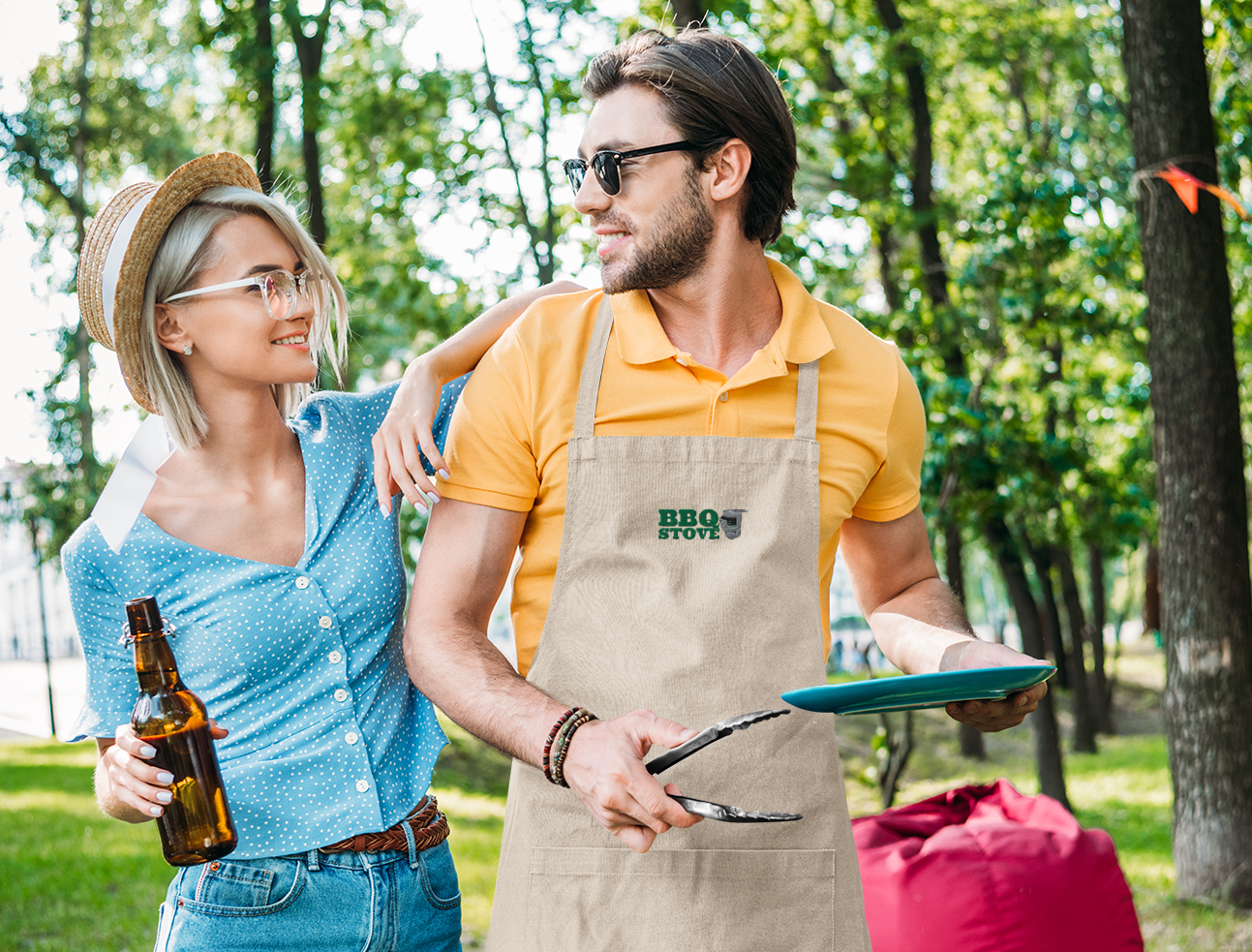 BBQ Stove man with apron preparing barbecue with girl holding bottle